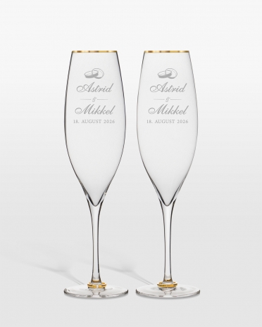 Champagneglass med gullringer på stetten og personlig gravering til brudeparet