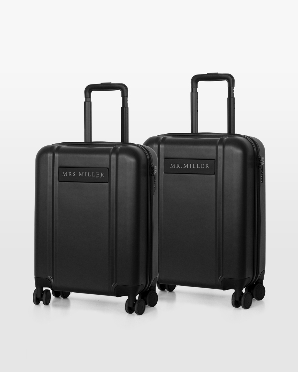 2-pakning med svarte håndbagasjer til bryllupsreisen